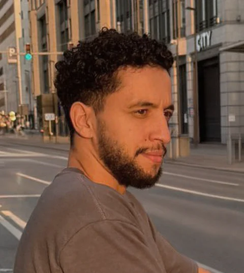 Portrait of Nabil Jabour in warm evening light on a city street