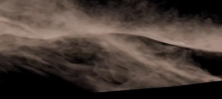 Thin streaks of sand whipping across a dune, on black