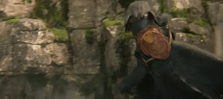 A black dragon slamming into a mossy cliff face
