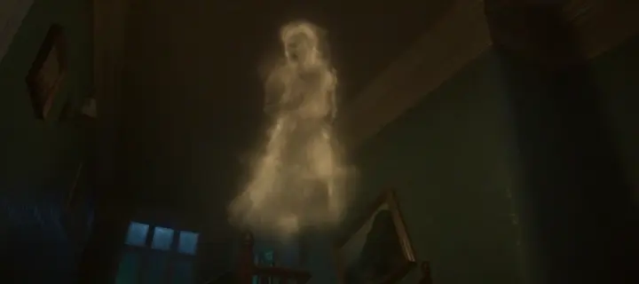 A pale ghost of a girl forming out of smoke in a dark room
