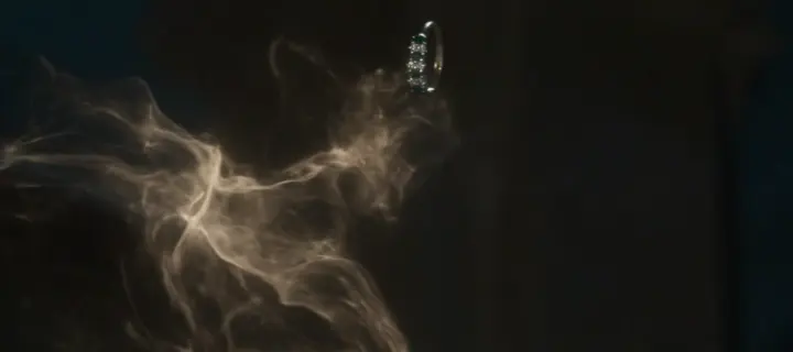 Wisps of glowing smoke curling around a falling ring
